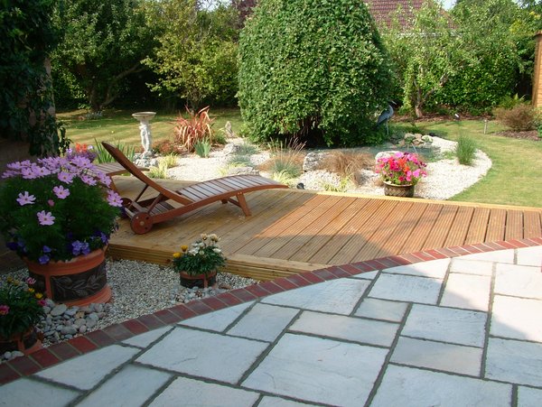 garden design Sandstone and decking curved brick edging