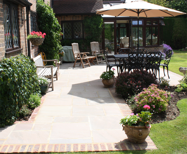 shaded_patio_indian_sandstone_brick_edging_nutbourne.jpg
